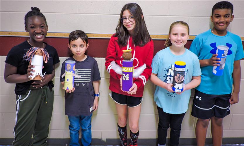 Students hold up Characters in a Can